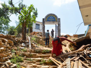 Amid Demolition and Reconstruction, Nepalese Children File into Temporary Classrooms of Bamboo and Tin